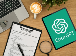 Image of a desk with a resume and a tablet displaying the ChatGPT logo