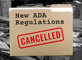 A folder labeled "New ADA Regulations" in front of a black and white pile of papers. The folder has been stamped with the word "Cancelled."